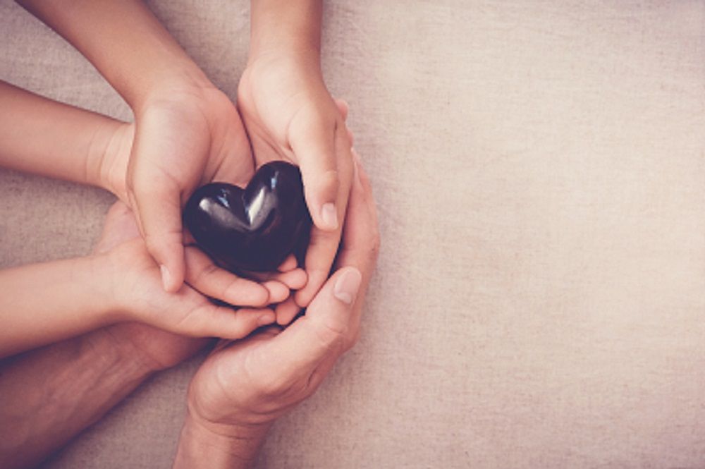 Hands Holding Heart Shaped Rock